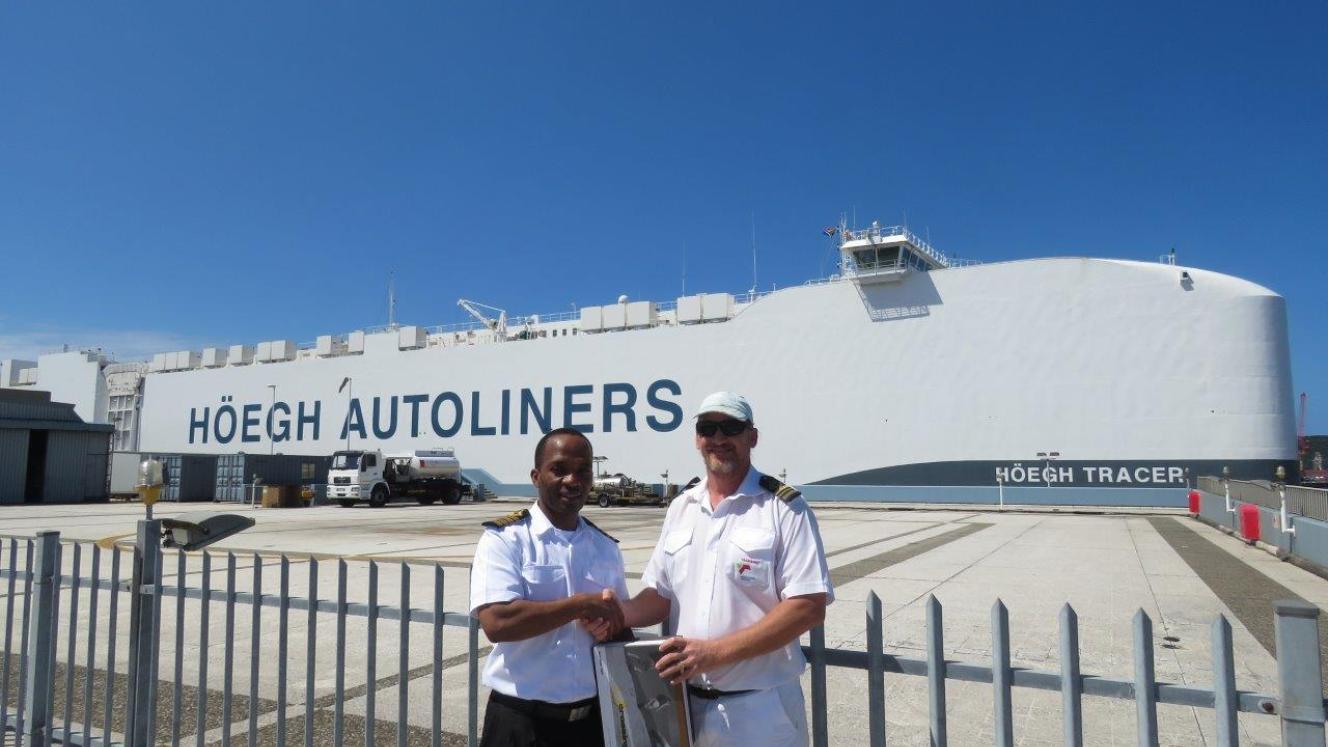 Marine pilot Rainer Rauntenberg (right) receives a gift from the Port of Durban harbour master Alex Miya.
