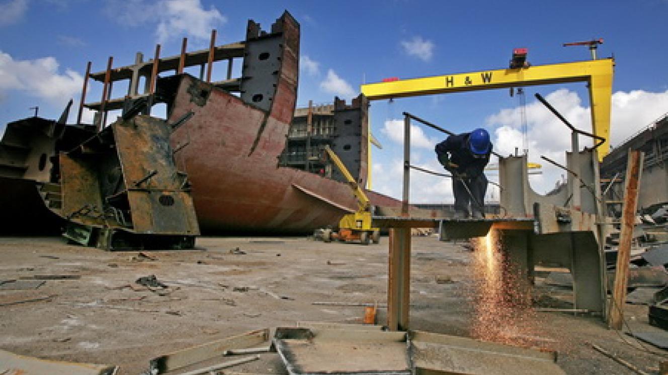 A worker cuts up pieces of the MSC Napoli cargo ship in a dry dock in Belfast, Northern Ireland.