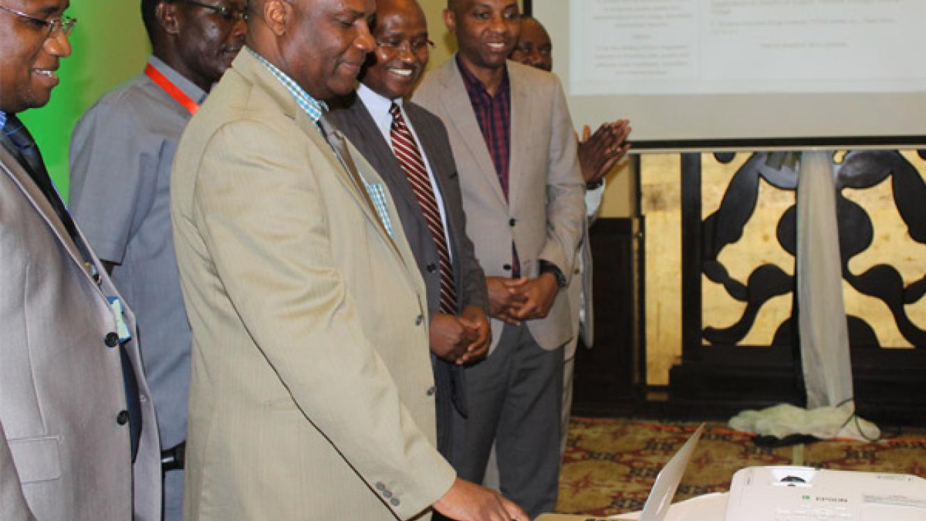 Tanzania chief medical officer, Professor Mohammed Bakari, launches the TFDA online portal. He is flanked by the TFDA director general, Hiiti Sillo.