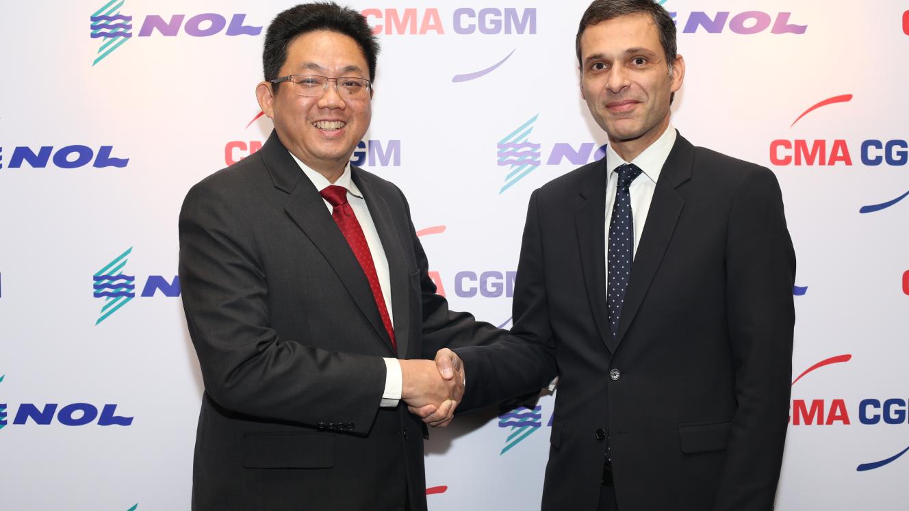 Rodolphe Saadé, vice-chairman of CMA CGM, and Ng Yat Chung, CEO of NOL, seal the deal with a handshake.