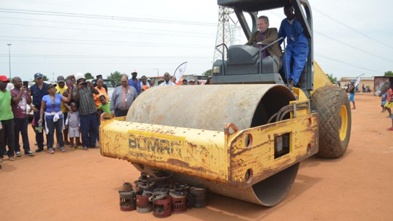 Minister of Trade and Industry, Dr Rob Davies, destroying illegal paraffin stoves confiscated in Tembisa.