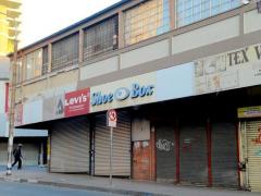 A man walks past closed shops after looting on September 2. 
