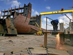 A worker cuts up pieces of the MSC Napoli cargo ship in a dry dock in Belfast, Northern Ireland.