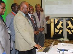 Tanzania chief medical officer, Professor Mohammed Bakari, launches the TFDA online portal. He is flanked by the TFDA director general, Hiiti Sillo.