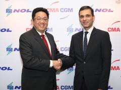 Rodolphe Saadé, vice-chairman of CMA CGM, and Ng Yat Chung, CEO of NOL, seal the deal with a handshake.