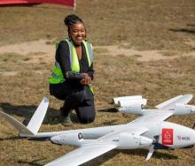 An official shows off the TRON Unmanned Aerial Vehicle (UAV)